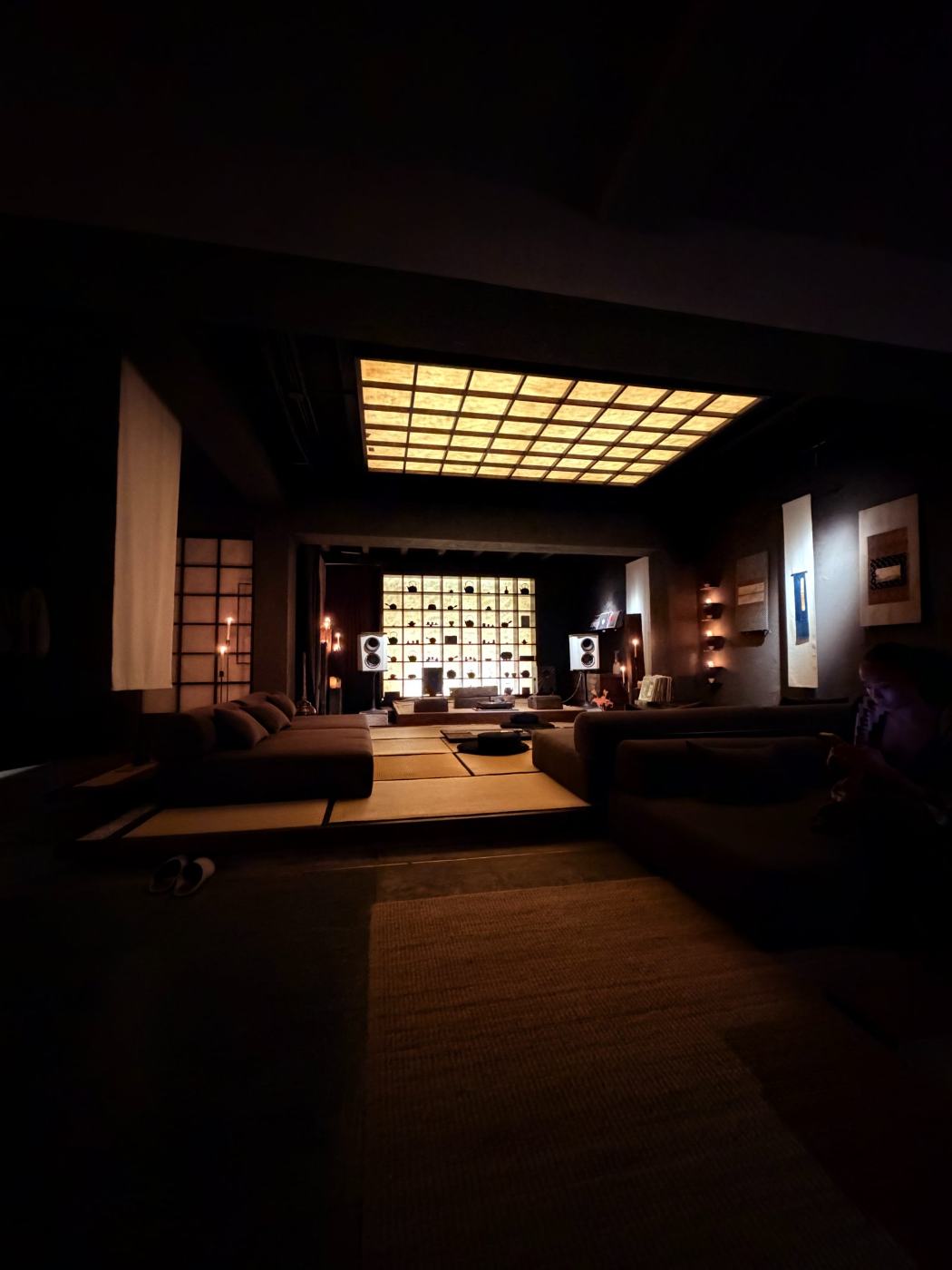 Evening lounge, lit teaware wall